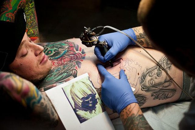 Tattoo Lovers Gather around for Epic Body Art