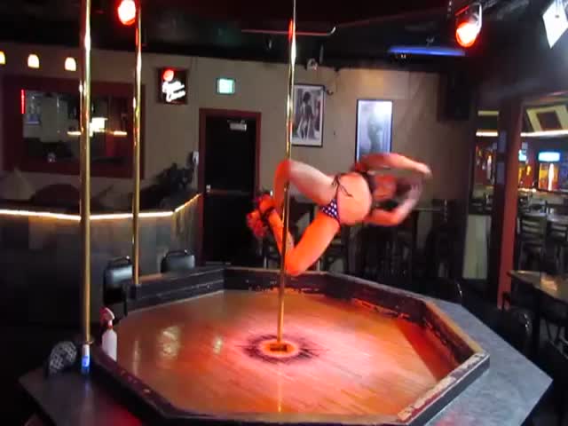 Talented Acrobatic Pole Dancer Practicing While the Strip Cub Is Empty 